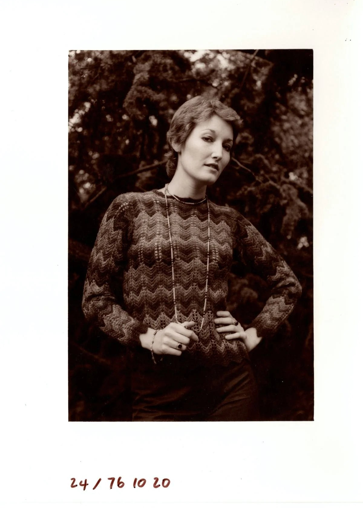 Vintage-style black and white photo of a woman wearing a Shetland shell lace sweater.