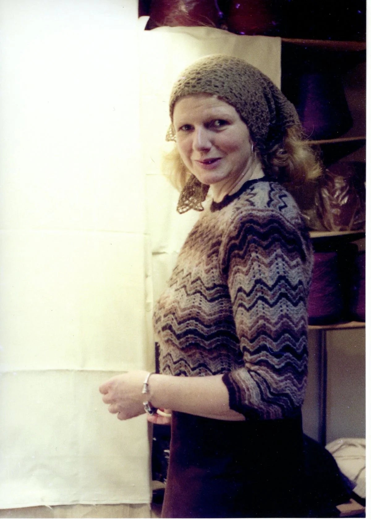 Gudrun Johnston's mom wearing a patterned sweater, featuring a Shetland shell lace pattern.
